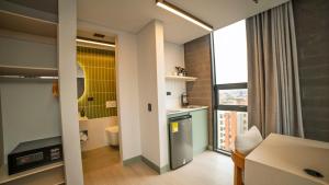 a room with a kitchen and a dining room at CITIO Hotel - Laureles in Medellín