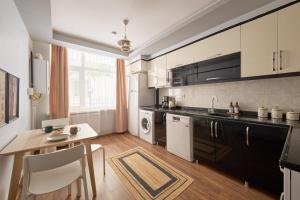 a kitchen with a table and a dining room at Kaira Homes 1 in Ankara