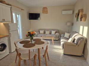 a kitchen and living room with a table and chairs at Maresia Apts & Studios in Arillas