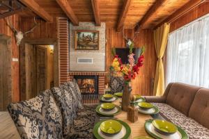 a dining room with a table and a fireplace at Anna Sela in Vrbov