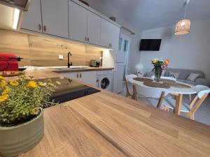 a kitchen and living room with a table and a dining room at Maresia Apts & Studios in Arillas