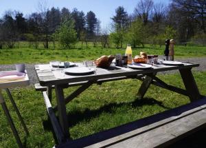 a picnic table with food on it in a field at F1 Ardennes Stay 5p Parking Bashfull in Amblève