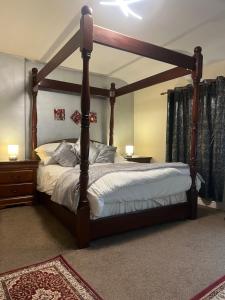 a bedroom with a bed with a wooden frame at Lynebank House Hotel, Bed & Breakfast in Carlisle