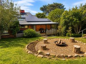 a fire pit in a yard in front of a house at Blue Mountains charm with Spa! in Wentworth Falls