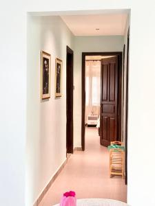 a hallway of a house with a door and pictures on the walls at comfort homes in Kampala