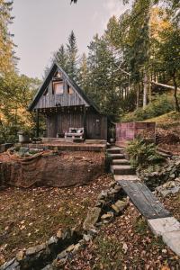 a small wooden house with stairs in the yard at OLA I Oáza Les Atmosféra I Oasis Forest Atmosphere in Petrov