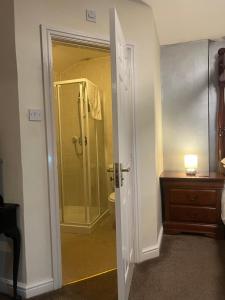 a bathroom with a shower and a toilet and a sink at Lynebank House Hotel, Bed & Breakfast in Carlisle +151 photos