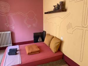 a bedroom with a bed with a drawing on the wall at Evasion Latine in Castelnau-Rivière-Basse
