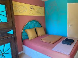 a bedroom with a bed in a room with a door at Evasion Latine in Castelnau-Rivière-Basse