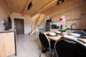 a kitchen and dining room with a table and chairs at Agroturystyka Oliweczka 29 in Potok Wielki