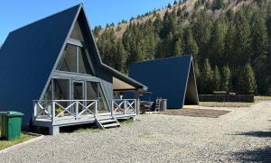 a couple of large buildings with trees in the background at Frame&Forest2 in Kolochava