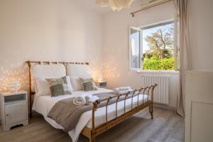 a bedroom with a large bed and a window at Serena Armando Exclusive Villas with Private Pools in Rosa Marina +56 photos