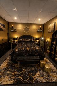 a bedroom with a large bed with a black comforter at Suite 3 Eighteen in Shelbyville