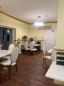 a waiting room with tables and chairs and a kitchen at Lynebank House Hotel, Bed & Breakfast in Carlisle