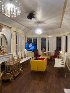 a living room with a yellow couch and chairs at Lynebank House Hotel, Bed & Breakfast in Carlisle
