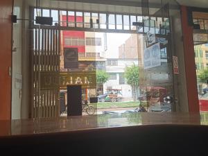 a view of a street from a glass window at Hotel Malibu in Chiclayo