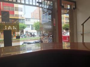 a view of a street from a building with a window at Hotel Malibu in Chiclayo