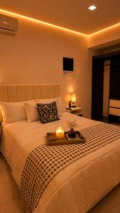 a bedroom with a large bed with a candle on it at Casa Amelia, 2 habitaciones - PRIME location, visa and passport in Mérida