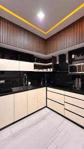 a kitchen with black and white cabinets and a sink at Casa Amelia, 2 habitaciones - PRIME location, visa and passport in Mérida +23 photos