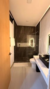 a bathroom with a shower and a toilet and a sink at Casa Amelia, 2 habitaciones - PRIME location, visa and passport in Mérida