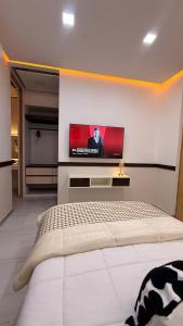 a bedroom with a flat screen tv on a wall at Casa Amelia, 2 habitaciones - PRIME location, visa and passport in Mérida