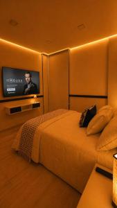 a bedroom with a bed with a flat screen tv at Casa Amelia, 2 habitaciones - PRIME location, visa and passport in Mérida