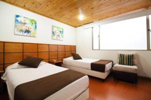Postel nebo postele na pokoji v ubytování Hotel Casa Quinta Embajada