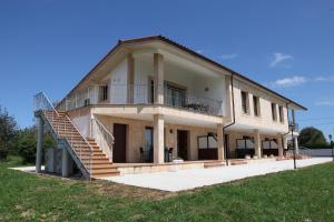 a large house with a staircase on the side of it at Apartamentos Los Novalejos in Arnuero