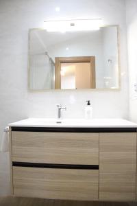 a bathroom with a sink and a mirror at Apartamentos Los Novalejos in Arnuero +59 photos