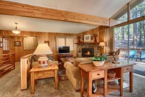 a living room with a couch and a fireplace at 10B Arrow Lodge in North Wawona