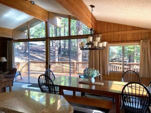 a dining room with a table and chairs and a large window at 10B Arrow Lodge in North Wawona