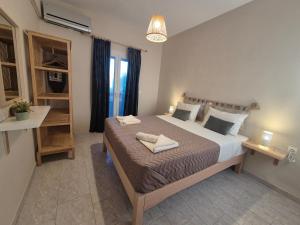 a bedroom with a bed with two towels on it at Maresia Apts & Studios in Arillas