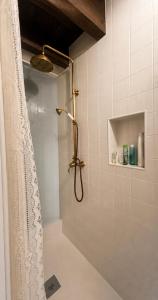 a shower with a shower curtain in a bathroom at Casa do Tio Zé Montesinho in Montezinho