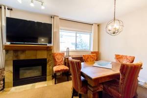 a dining room with a table and a fireplace at 09 Valhalla in Whistler