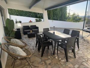 a patio with a table and chairs on a patio at Alex Guest House in Quinta do Anjo