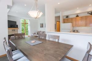 a dining room and kitchen with a table and chairs at Bright and Clean, Walk Everywhere, Shared Pool and Hot Tub in Whistler