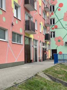 a building with flowers painted on the side of it at Apartament Blue Velvet in Skierniewice