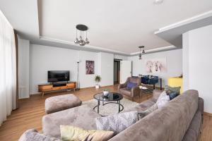 a living room with a couch and a tv at Kaira Homes 1 in Ankara