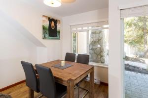 a dining room with a wooden table and chairs at 63 Lagoons in Whistler