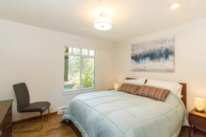 a bedroom with a bed and a desk and a chair at 63 Lagoons in Whistler +7 photos