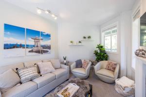 a living room with a couch and two chairs at Panoramic Views from this gorgeous 2 Bed Property - Village Location in Whistler