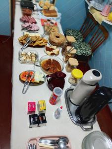 a table full of food on top at Hotel Linassi in Cruz Alta