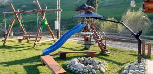 a playground with a slide and a swing at Domek w dolinie ciszy Pieniny in Grywałd