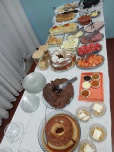 a table topped with lots of different types of food at Hotel Linassi in Cruz Alta