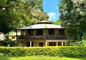 a large house with a balcony on top of it at Kilimanjaro Lodge - MCF in Moshi