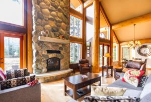 a large living room with a stone fireplace at 8140 Nicklaus North in Whistler