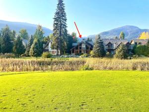a large house in the middle of a green field at 8140 Nicklaus North in Whistler