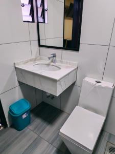 a bathroom with a sink and a toilet and a mirror at Hostal Face in La Paz