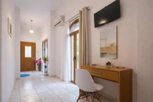 a home office with a desk and a chair at Natsios Apartments in Vlachopoulátika