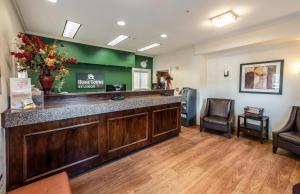 a bar in a waiting room at a hospital at HomeTowne Studios by Red Roof Orlando South in Orlando